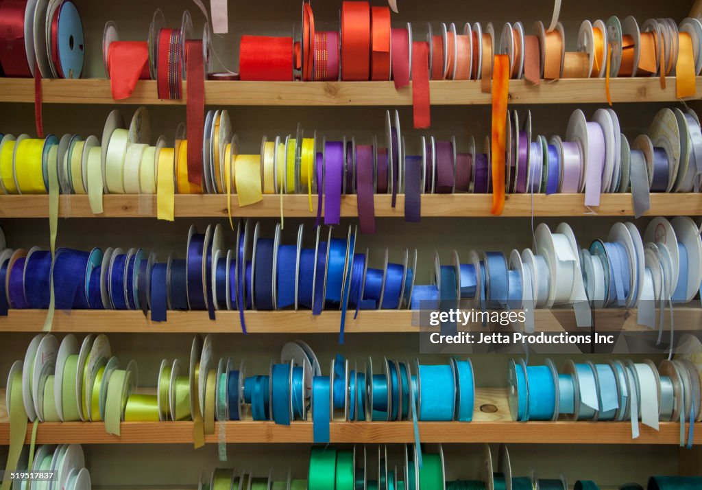 Shelves of multicolor ribbons on store shelf