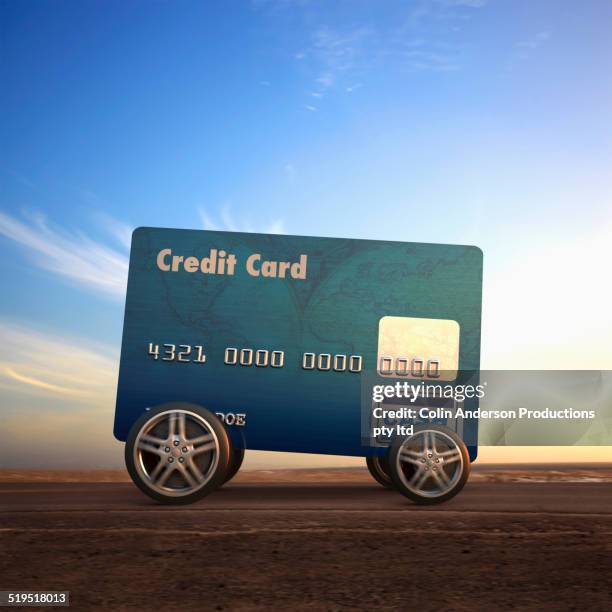 car made out of credit card driving on remote road - voiture digital photos et images de collection