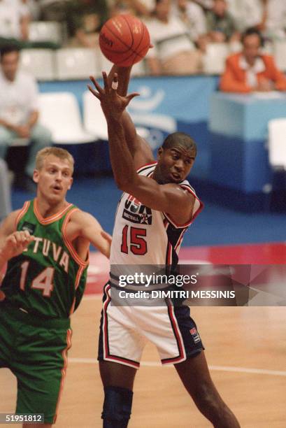 Earvin "Magic" Johnson grabs a rebound in front of Lithuanian Gintaras Einikis, 06 August 1992, during their semi-final match at the 1992 Barcelona...