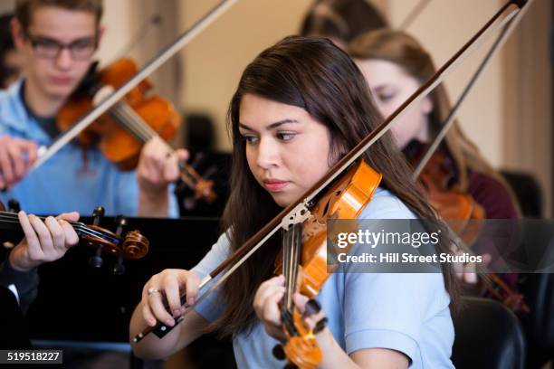 students playing violin in music class - boy violin stockfoto's en -beelden