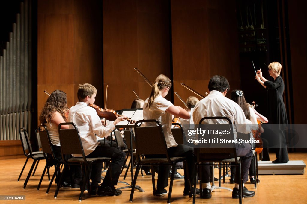 Student orchestra playing on stage