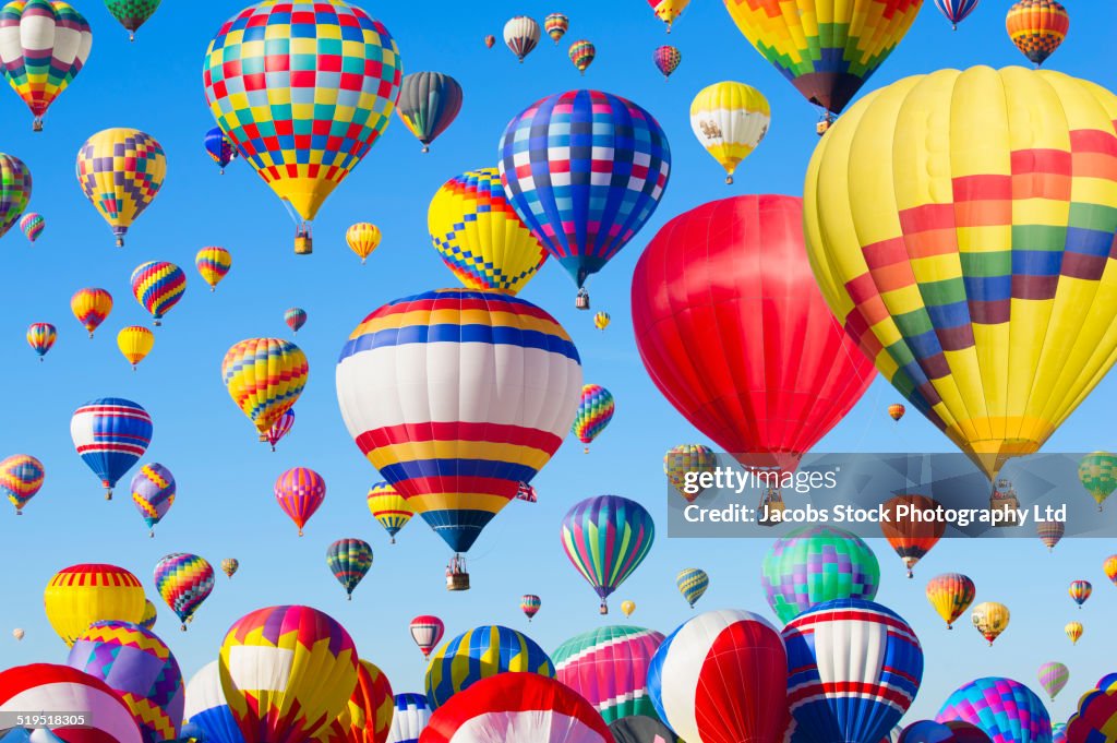 Hot air balloons floating in blue sky