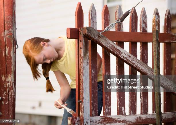 caucasian girl painting fence - white picket gate stock pictures, royalty-free photos & images
