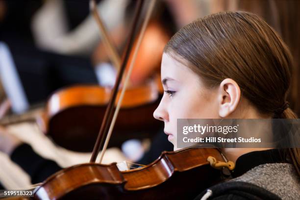 caucasian girl playing violin in orchestra - writing instrument bildbanksfoton och bilder