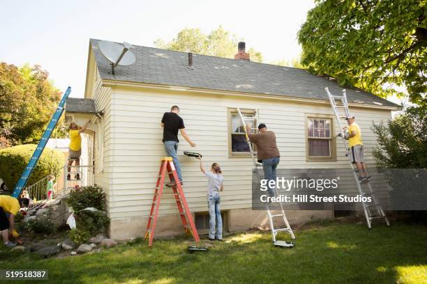 people painting house - teenager alter stock-fotos und bilder