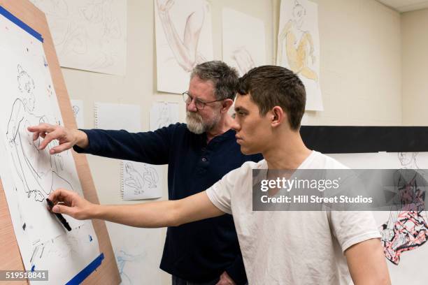 caucasian artist teaching student in studio - art easel stock pictures, royalty-free photos & images