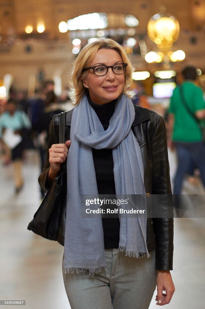 Caucasian woman walking in Grand Central Station, New York City, New York, United States