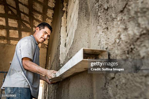 hispanic construction worker at construction site - hispanic construction worker stock pictures, royalty-free photos & images