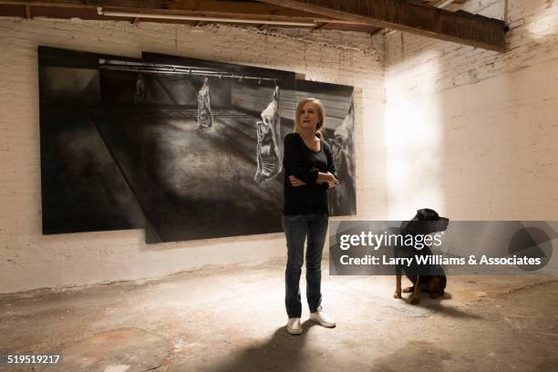 woman and dog standing in art gallery - galerie art stock-fotos und bilder