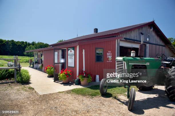 tractor outside rural farm store - michigan farm stock pictures, royalty-free photos & images