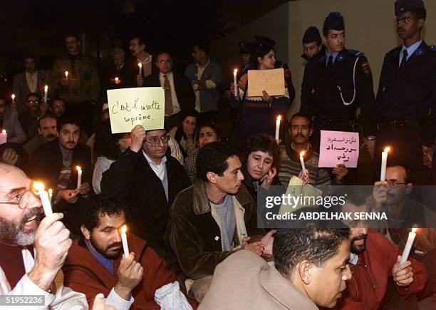 Holding candles "of mourning", some 50 human rights militants demonstrate outside the Rabat home of Moroccan Prime Minister Abderrahmane Youssoufi,...