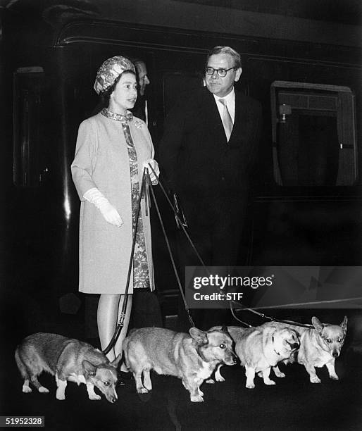 Queen Elizabeth II arrives at King's Cross railway station in London 15 October 1969 with her four dogs of Corgis breed after holidays in Balmoral...