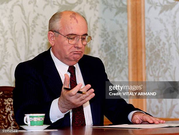 Soviet President Mikhail Gorbachev reads his resignation statement shortly before appearing on television in Moscow, 25 December 1991, to announce...