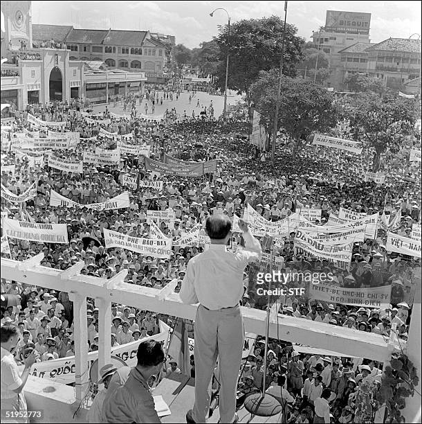 An unidentified member of the Vietnamese National Popular Council speaks to protesters demonstrating in support of the policy of Premier general Ngo...