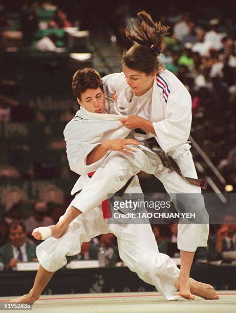 France's Olympic team Marie-Claire Restoux throws Australian Catherine Brain to win round 2 of women's 52kg-division Olympic judo competition 25 July...
