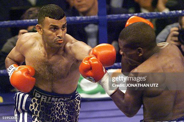 Prince Naseem Hamed of England punches contender Vuyani Bungu of South Africa during their WBO Featherweight title bout 11 March 2000 at the Olympia...