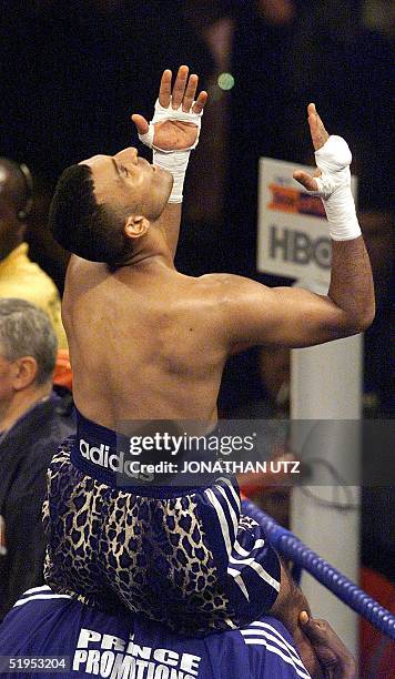 On the shoulders of his trainer Prince Naseem Hamed of England savours his win over contender Vuyani Bungu of South Africa after their WBO...