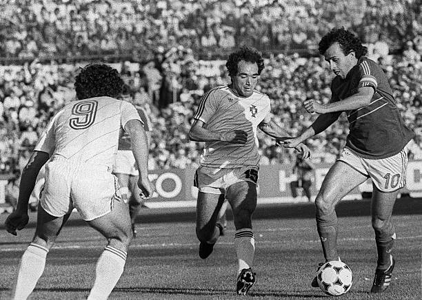 French captain and midfielder Michel Platini tries to dribble by Portuguese Jaime Pacheco as Joao Pinto looks on, during the European Nations soccer...