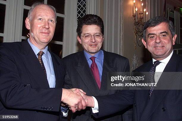 Presidents of the Amsterdam, Brussels and Paris stock exchanges, George Moller, Olivier Lefebvre and Jean-Francois Theodore shake hands 20 March 2000...