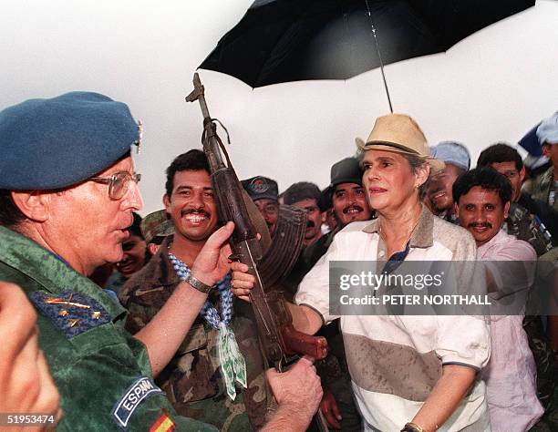 President of Nicaragua Violeta Chamorro receives an AK-47 assault rifle from a member of the contra forces to symbolize the end of the war, 09 June...