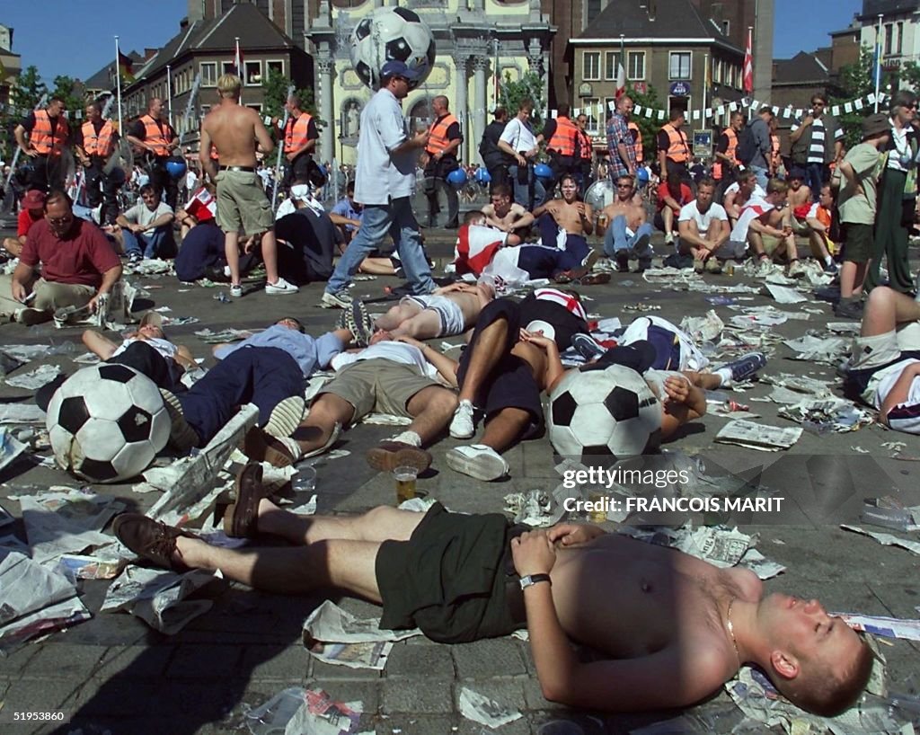 Drunken football fans rest on Charleroi Charles II