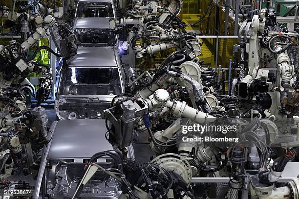 Robotic arms weld the body frames of Daihatsu Motor Co. Vehicles on the production line of the Daihatsu Motor Kyushu Co. Oita plant in Nakatsu, Oita...