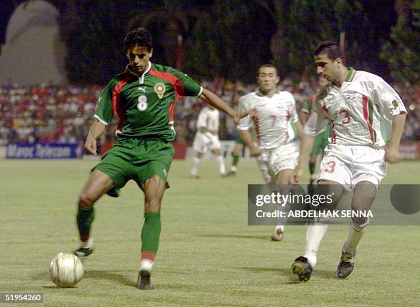 Moroccan striker Said Siba vies with Algerian defender Mariana Youssef in Fes 09 July 2000 during their second round match for the 2002 World Cup....