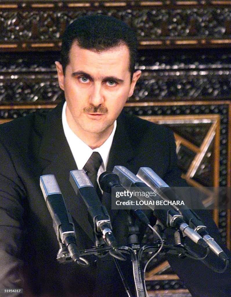 Syria's new President Bashar al-Assad (C) addresse