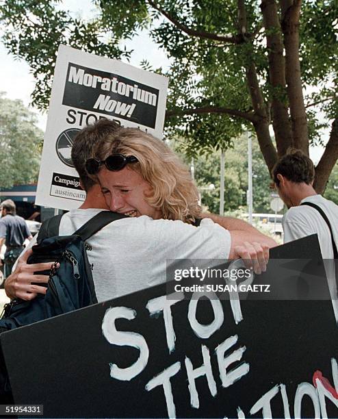 Protesters from the "Campaign to End the Death Penalty" console each other 22 June, 2000 in Austin, TX, following the announcement that the Texas...