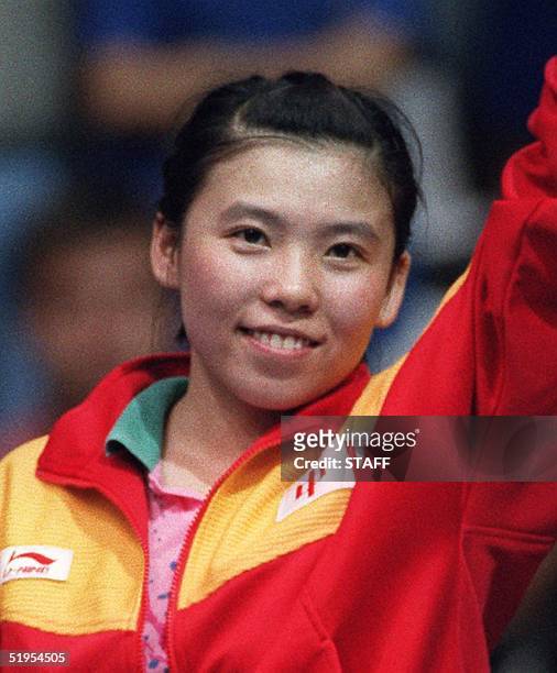Deng Yaping of China smiles on the podium after winning, with teammate Qiao Hong, the gold medal in the women's double table tennis final at the...