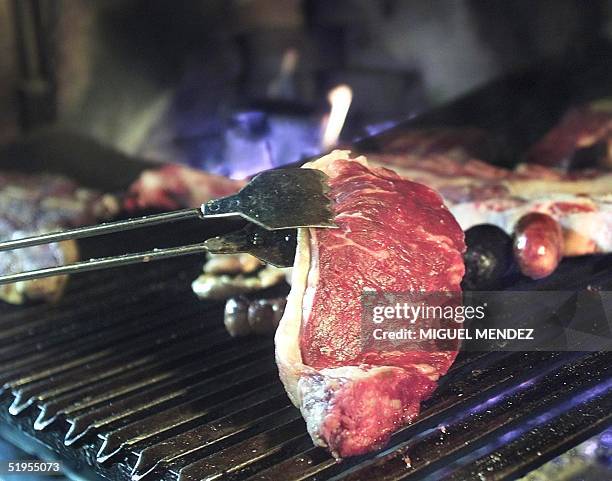 Steak of Argentine beef is put on the grill of a barbecue restaurant in Buenos Aires, Argentina, 08 November 2000. Argentina is famous for the...
