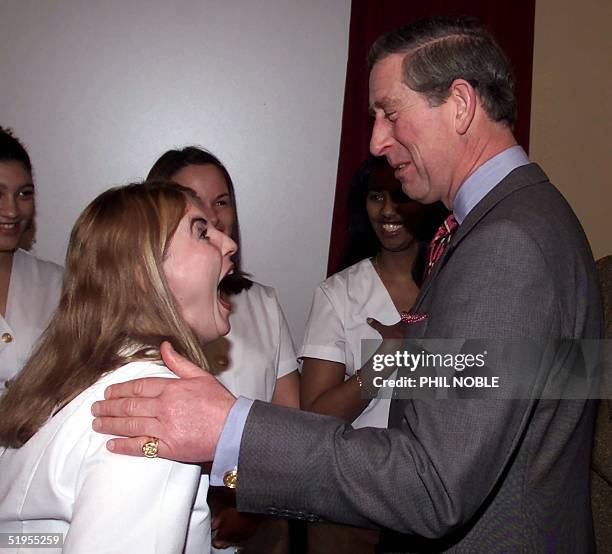 Deaf hairdresser Nikki McCormack roars with laughter as she shares a joke with Britain's Prince Charles at the Museum of Liverpool Life in the...