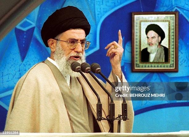 Iranian supreme leader Ayatollah Ali Khamenei delivers a sermon at Tehran University's weekly Friday prayers 15 December 2000, with a portrait of his...