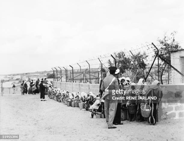Palestinian refugees queue for food distributed by the UNRWA at a camp in Gaza 09 November 1956. Des rTfugiTs palestiniens attendant la distribution...