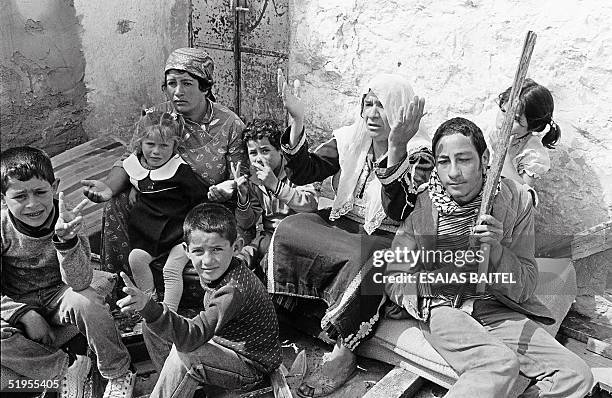 Palestinian family sits in her house in Kalandia, west bank, 27 March 1985, destroyed by the Israli army. Une famille palestinienne est assise dans...