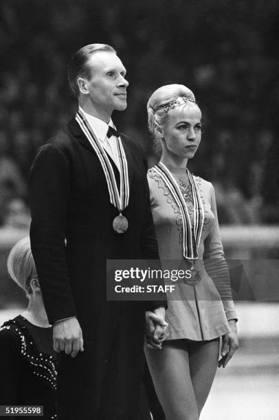 Lyudmila Belousova and her partner Oleg Protopopov from the Soviet Union stand of the podium of the figure skating pairs competition 15 february 1968...