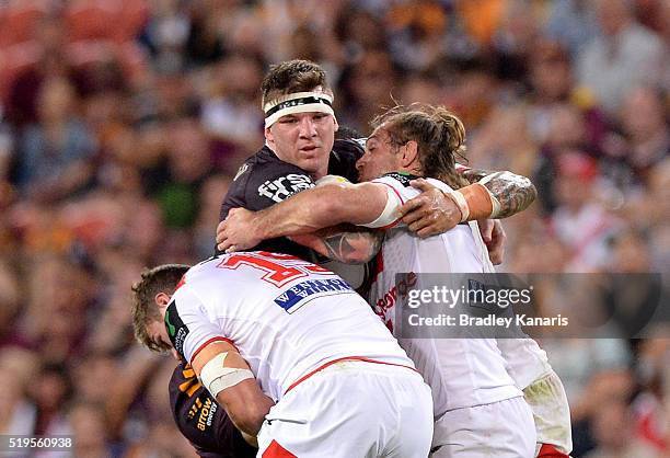 Josh McGuire of the Broncos is tackled during the round six NRL match between the Brisbane Broncos and the St George Illawarra Dragons at Suncorp...