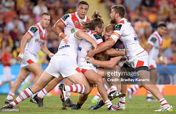 Jack Reed of the Broncos is wrapped up by the defence during the round six NRL match between the Brisbane Broncos and the St George Illawarra Dragons...
