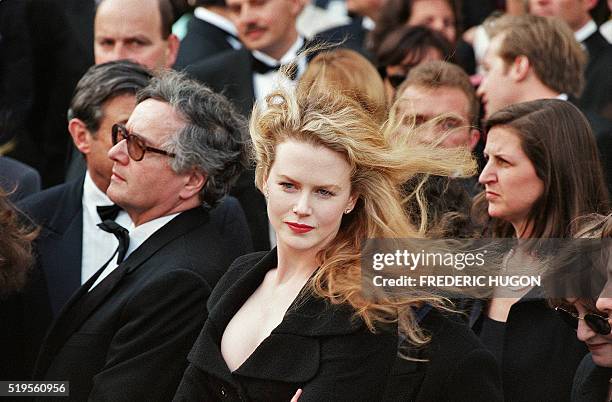 Actress Nicole Kidman , who is married to US actor Tom Cruise, poses for photographers before climbing the steps of the Festival Palace in Cannes 19...