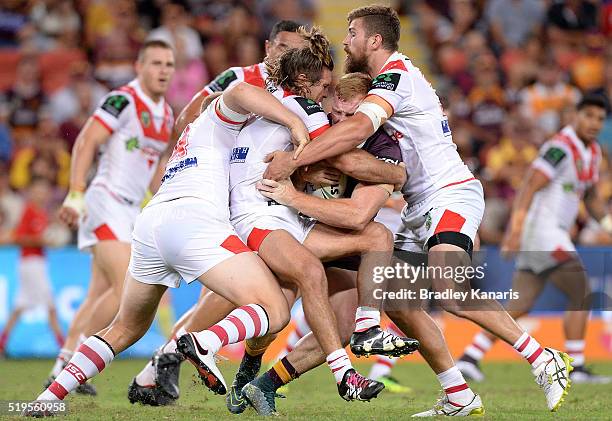 Jack Reed of the Broncos is wrapped up by the defence during the round six NRL match between the Brisbane Broncos and the St George Illawarra Dragons...
