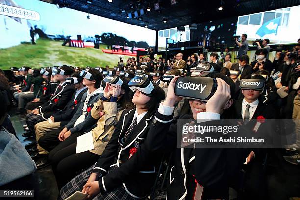 Students wearing virtual reality headsets watch a video broadcast from N High School's main campus in Okinawa Prefecture at an entrance ceremony held...