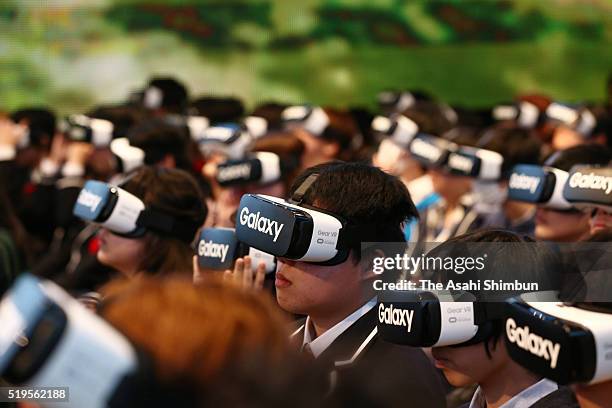 Students wearing virtual reality headsets watch a video broadcast from N High School's main campus in Okinawa Prefecture at an entrance ceremony held...