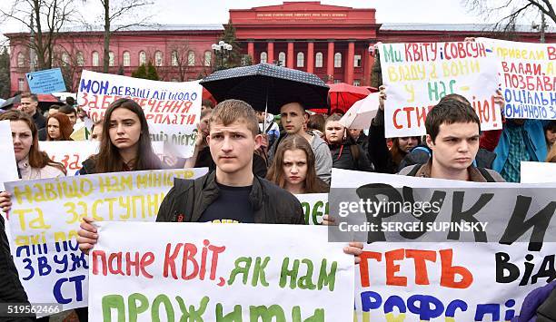 Ukrainian university students hold placards reading "We demand scholarship indexing", "Hands off of student unions", "We demand quality education"...