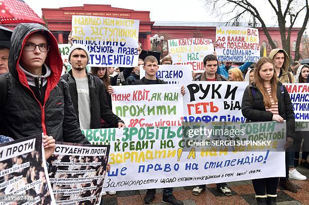 Ukrainian university students hold placards reading "We demand scholarship indexing", "Hands off of student unions", "We demand quality education"...