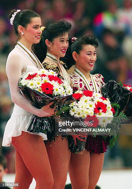 Kristi Yamaguchi from the United States, her compatriot Nancy Kerrigan and Japanese Midori Ito smile as they pose on the podium after the medals'...