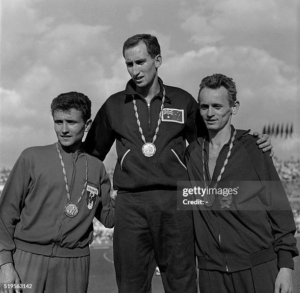 Medalists of the 1500m, Australian gold Herb Elliott , French silver Michel Jazy and Hungarian bronze Itsvan Rozsavolgi stand on the olympics podium,...