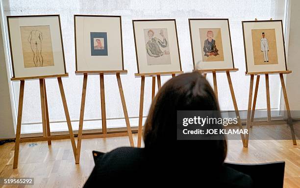 Woman looks at five aquarels and drawings by Austrian painter Egon Schiele displayed during a press conference at Vienna's famous Leopold Museum in...