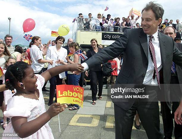 Britain's Prime Minister Tony Blair greets a young well-wisher as he visits Saltdean Community Club, Brighton, East Sussex, 31 May 2001. Mr Blair...