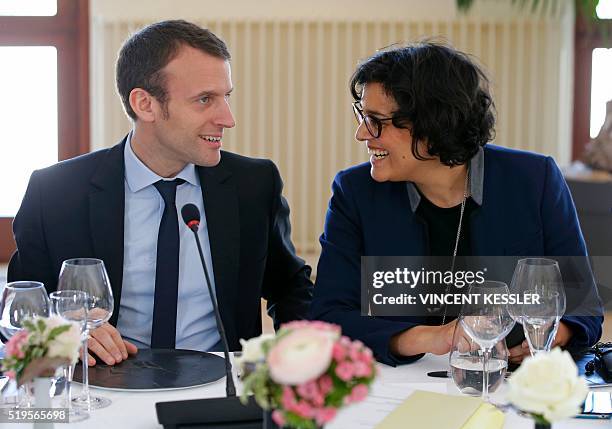 French Labour Minister Myriam El Khomri talks to Economy Minister Emmanuel Macron as they attend a lunch of the 18th Franco-German cabinet meeting in...