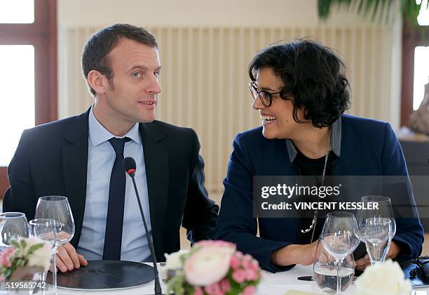 French Labour Minister Myriam El Khomri talks to Economy Minister Emmanuel Macron as they attend a lunch of the 18th Franco-German cabinet meeting in...